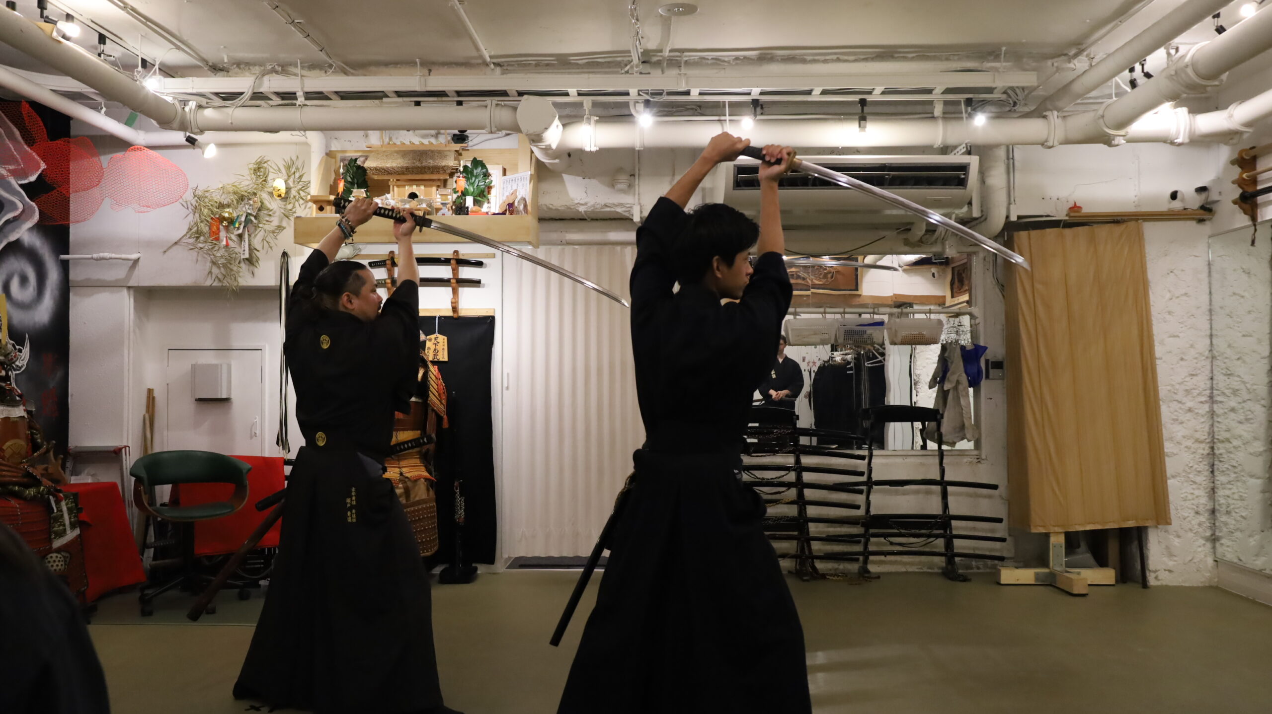 A family in samurai attire training privately at Yushinkan, Kyoto