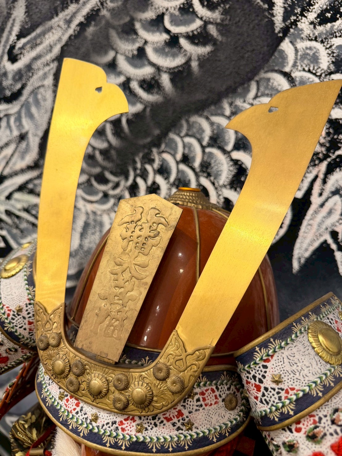 Close-up of golden kuwagata crest on a samurai helmet