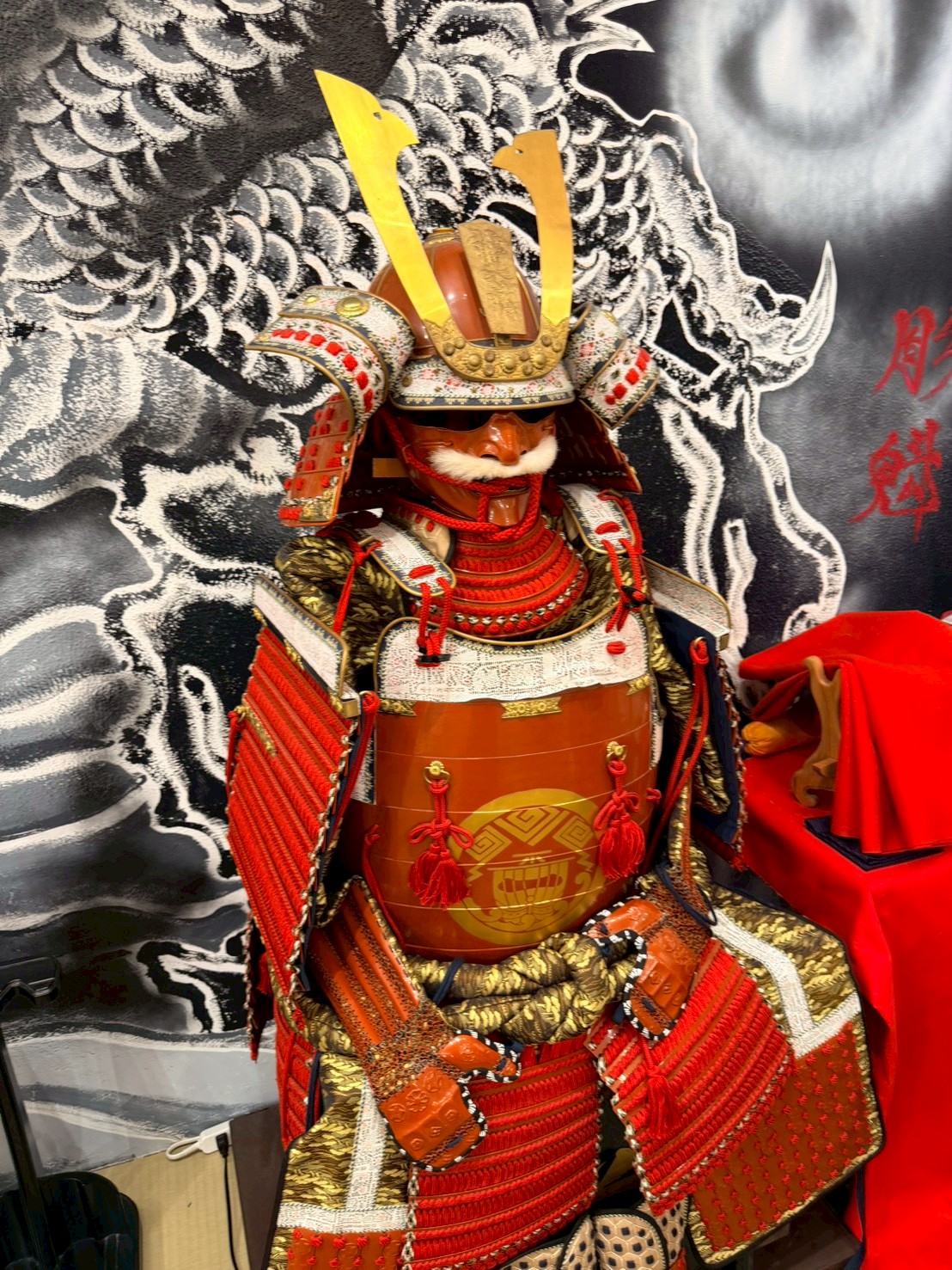 Full set of red-laced Japanese samurai armor (yoroi) on display at Yushinkan Kyoto